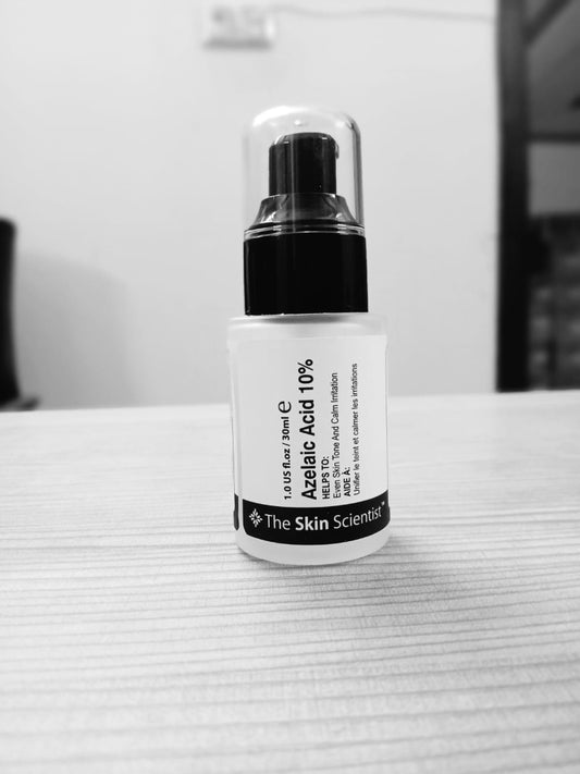 Skincare bottle labeled 'The Skin Scientist' on a textured surface